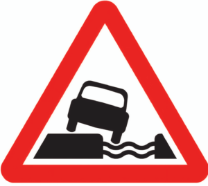 Water Course Alongside Road Ahead Warning Sign – Diagram 555.1B showing car hazard near ditch or canal in red triangle format
